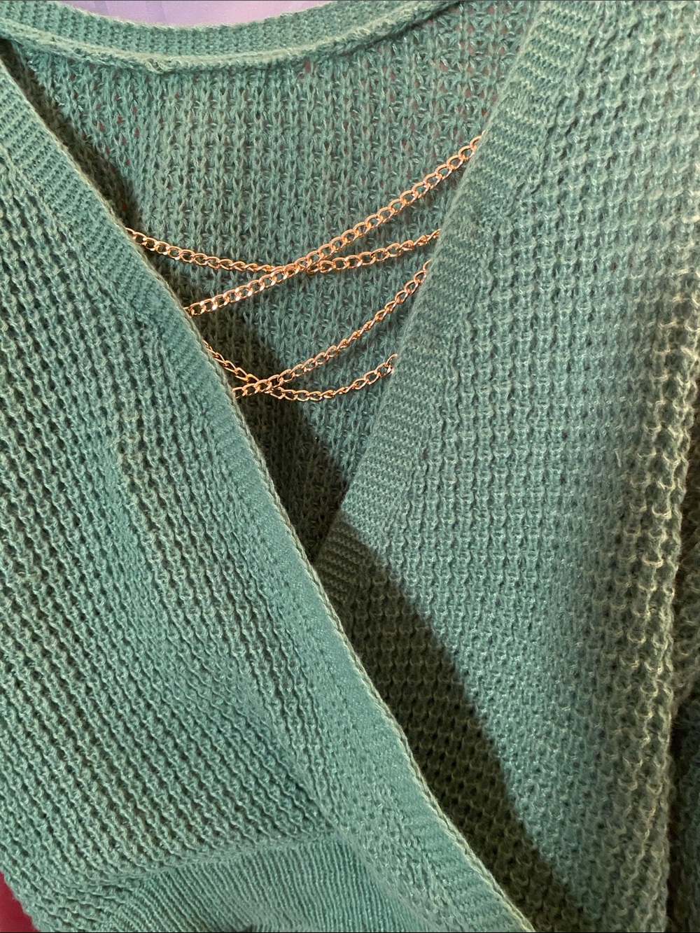 Pre-Loved Green Sweater with Hanging Criss Cross Gold Chains in the Back.